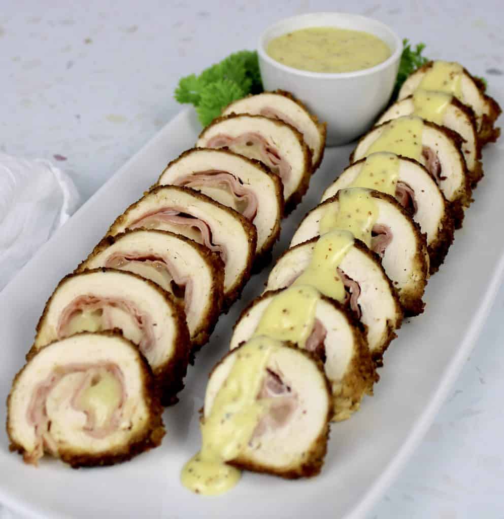 two rows of sliced chicken cordon bleu on white plate
