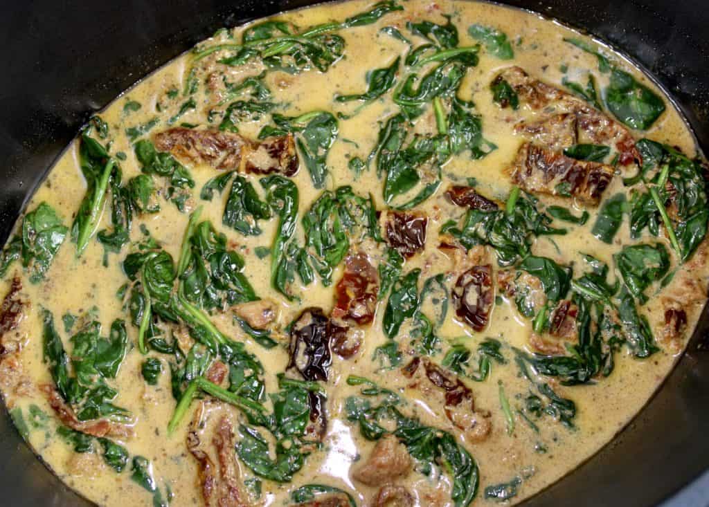 tuscan cream sauce with spinach in crockpot insert