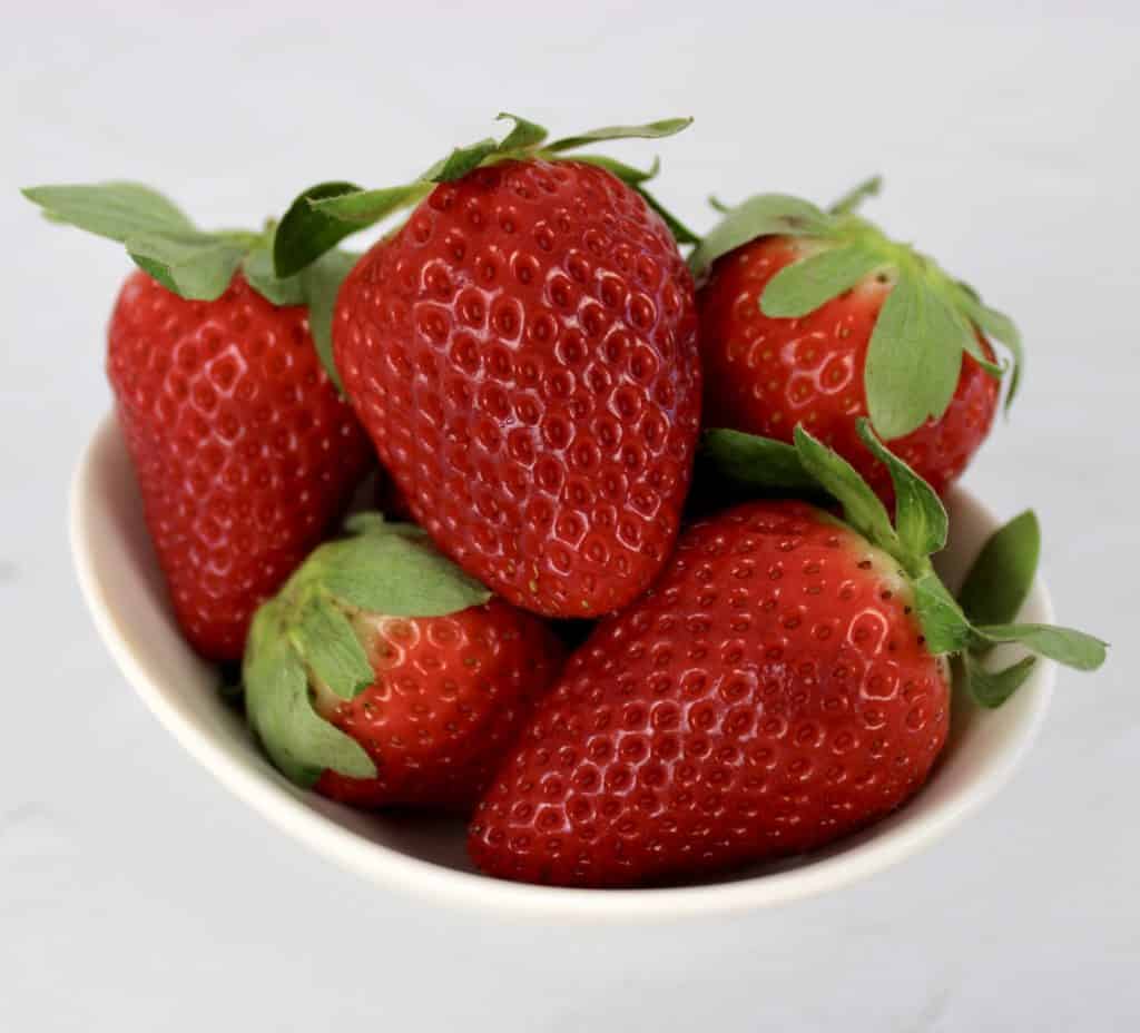 closeup of strawberries in white bowl