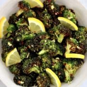 overhead view of Air Fryer Broccoli in bowl with lemon slices