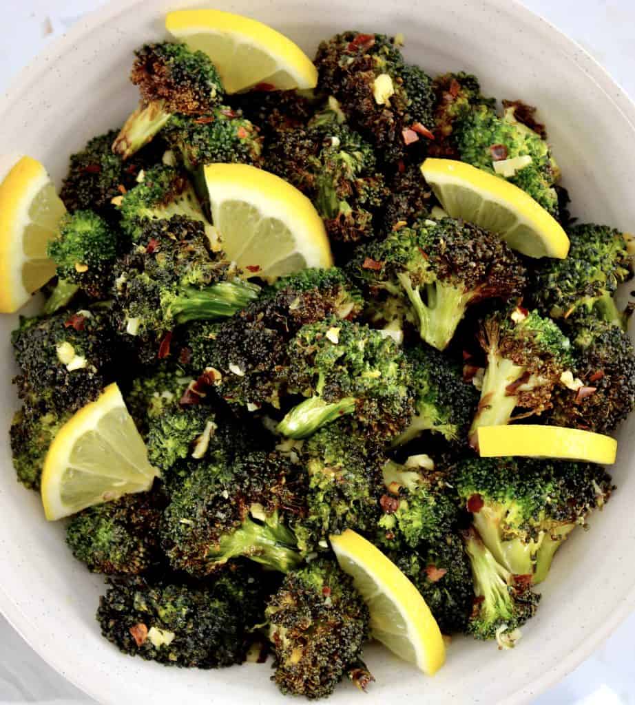 overhead view of Air Fryer Broccoli in bowl with lemon slices