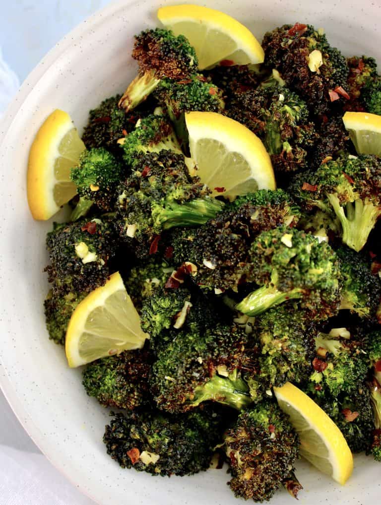 overhead view of Air Fryer Broccoli in bowl with lemon slices