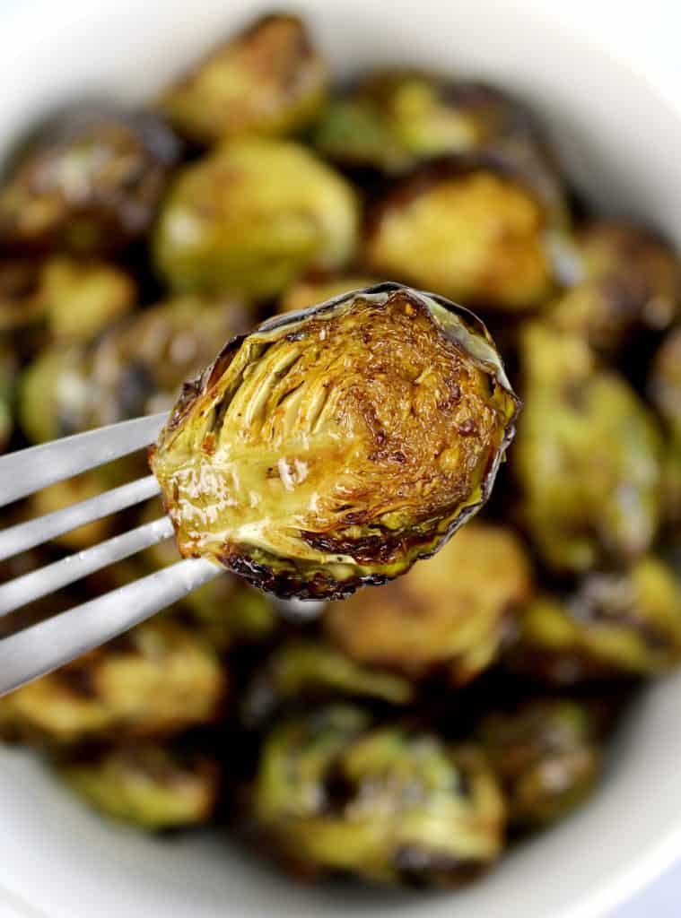Air Fryer Brussels Sprouts with fork holding up one