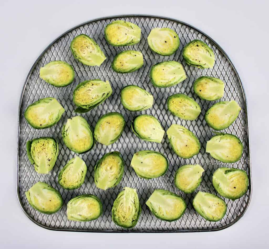 Brussels sprouts cut in half on air fryer rack
