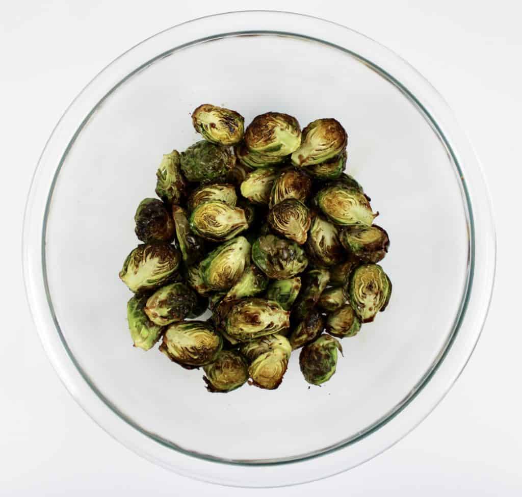 roasted Brussels sprouts in glass bowl with balsamic vinegar