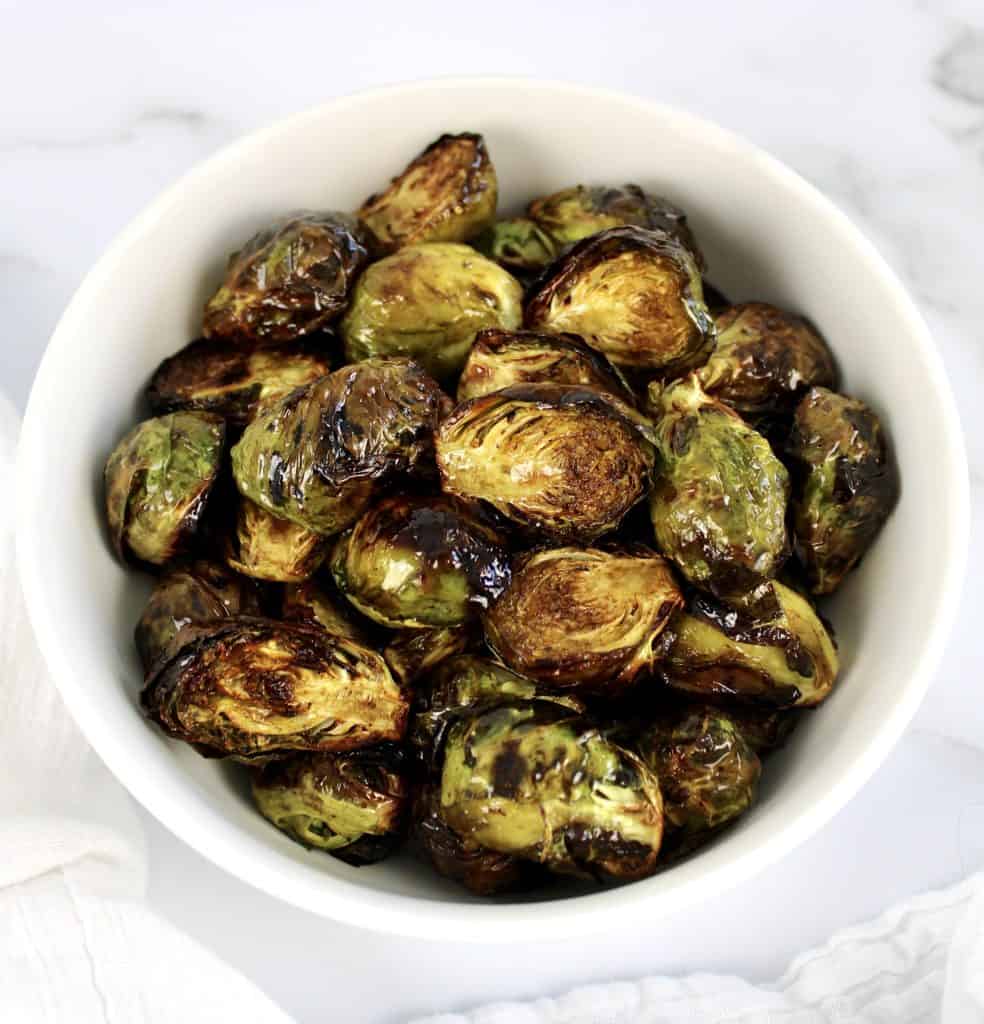 Air Fryer Brussels Sprouts in white bowl with balsamic vinegar