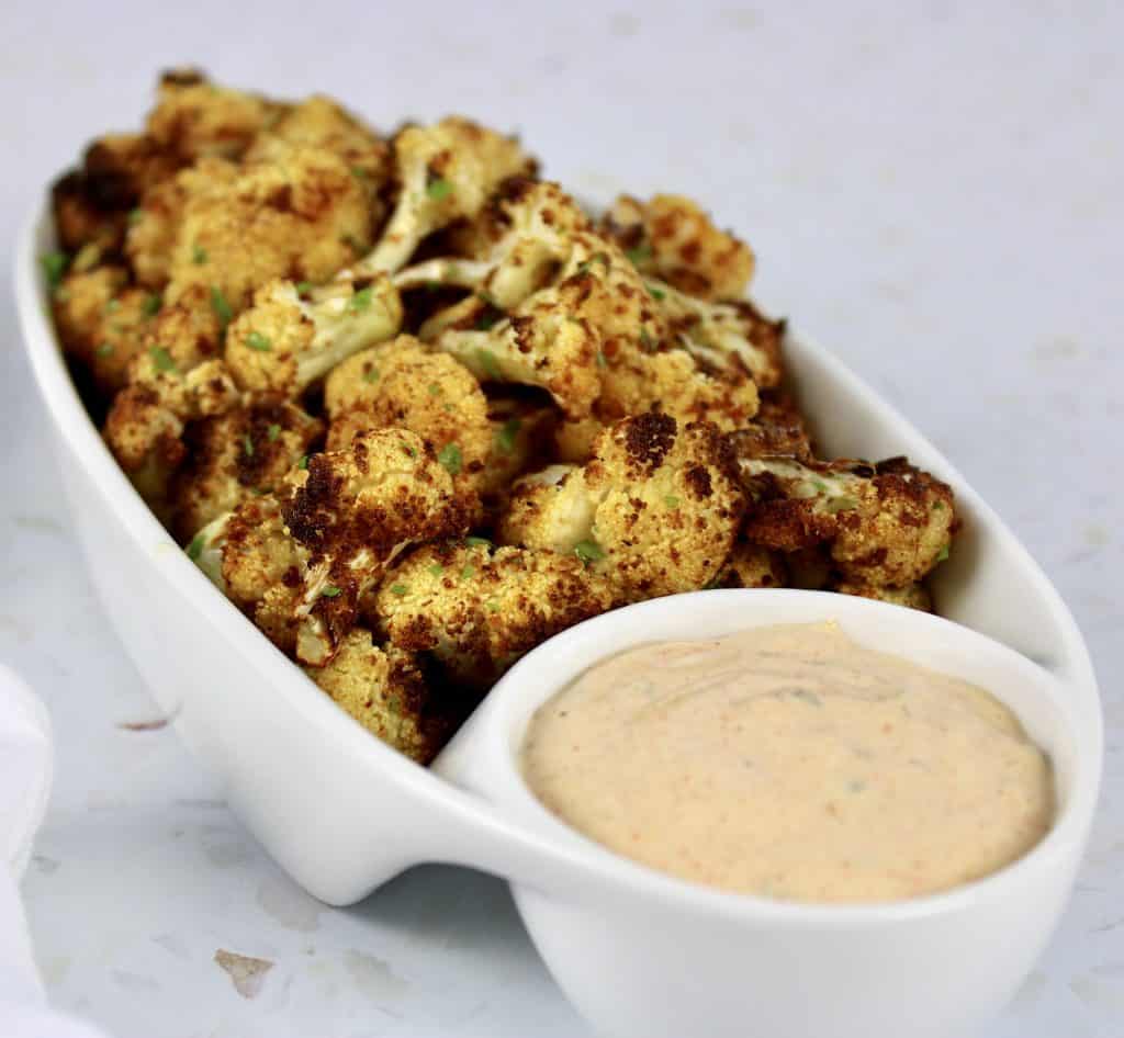 Air Fryer Cauliflower with Dipping Sauce in white serving dish