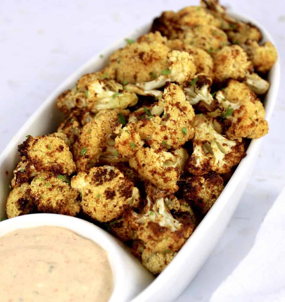 Air Fryer Cauliflower with Dipping Sauce on side in white serving dish