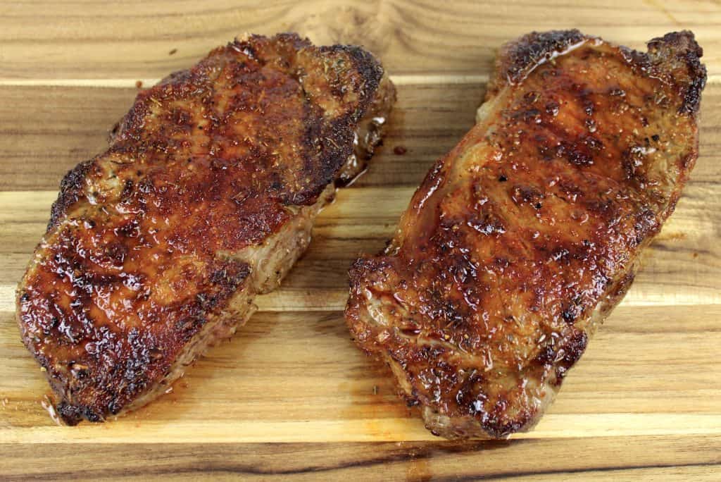 2 cooked Air Fryer Steaks on cutting board