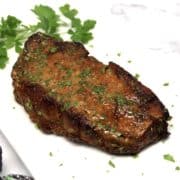 Air Fryer Steak on white plate with parsley