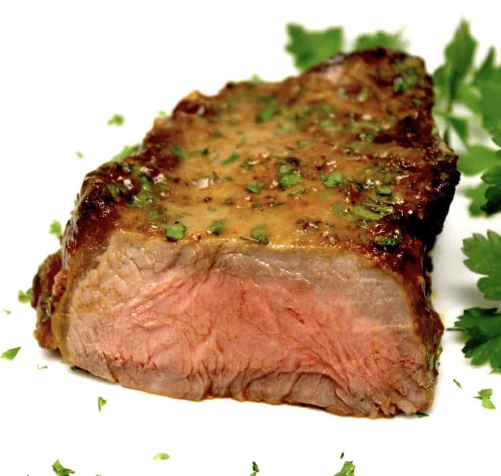 piece of steak cut open on white plate