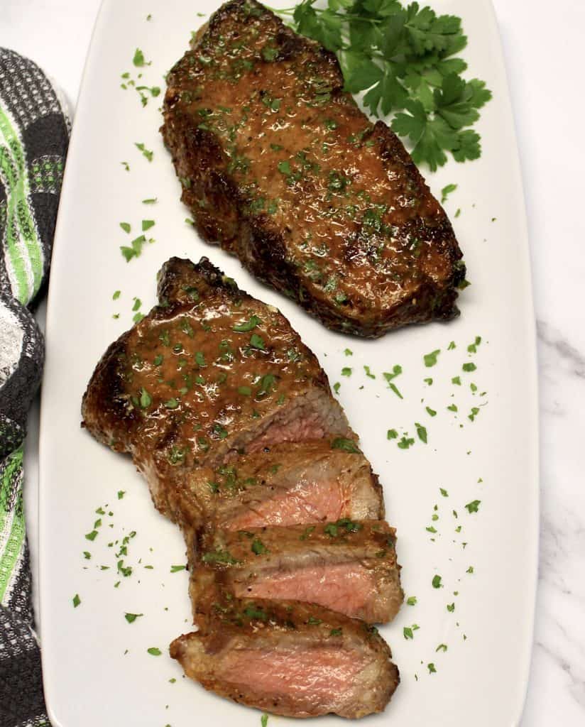 2 Air Fryer Steaks on white plate one cut in 3 piecesw