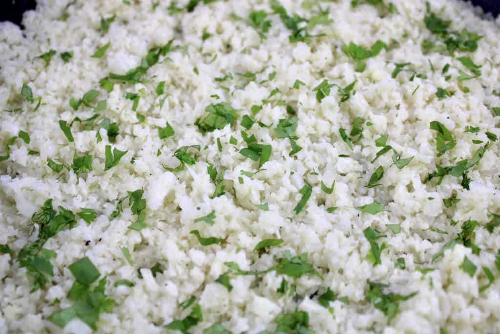 closeup of Coconut Cauliflower Rice with chopped cilantro