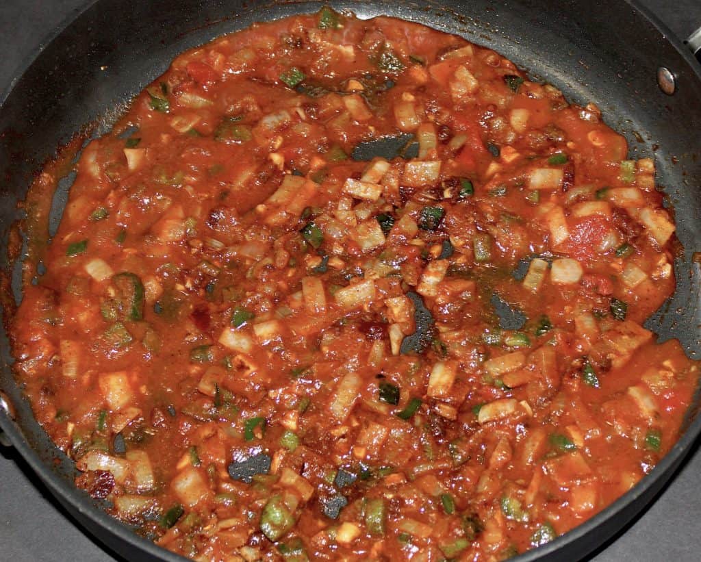 tomato sauce with chopped veggies in skillet