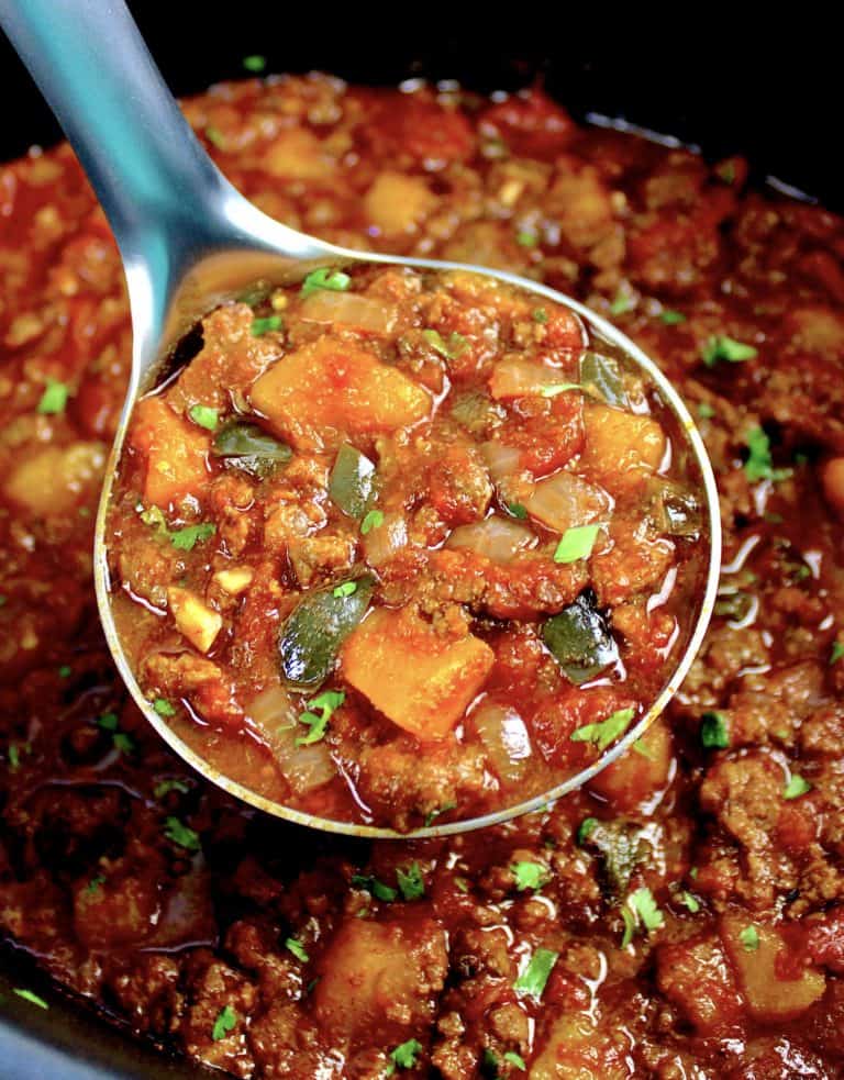 chili with butternut squash in crockpot with ladle full