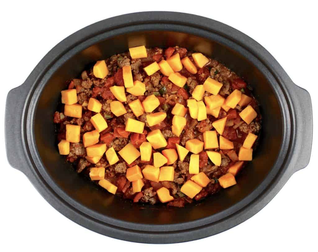 Crockpot Chili with Butternut Squash on top uncooked in slow cooker insert