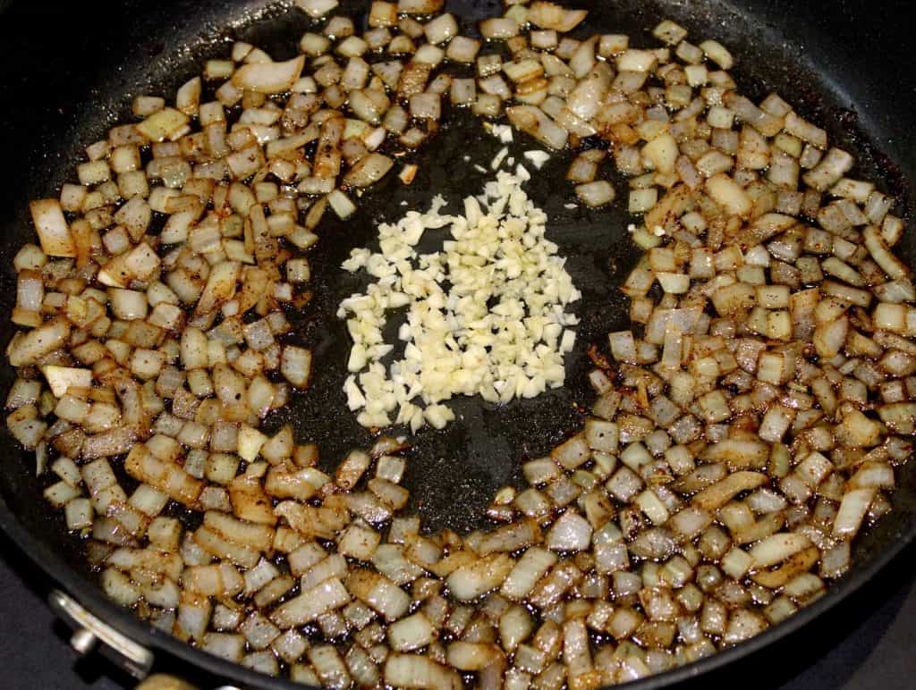 diced onion and garlic sautéeing in skillet