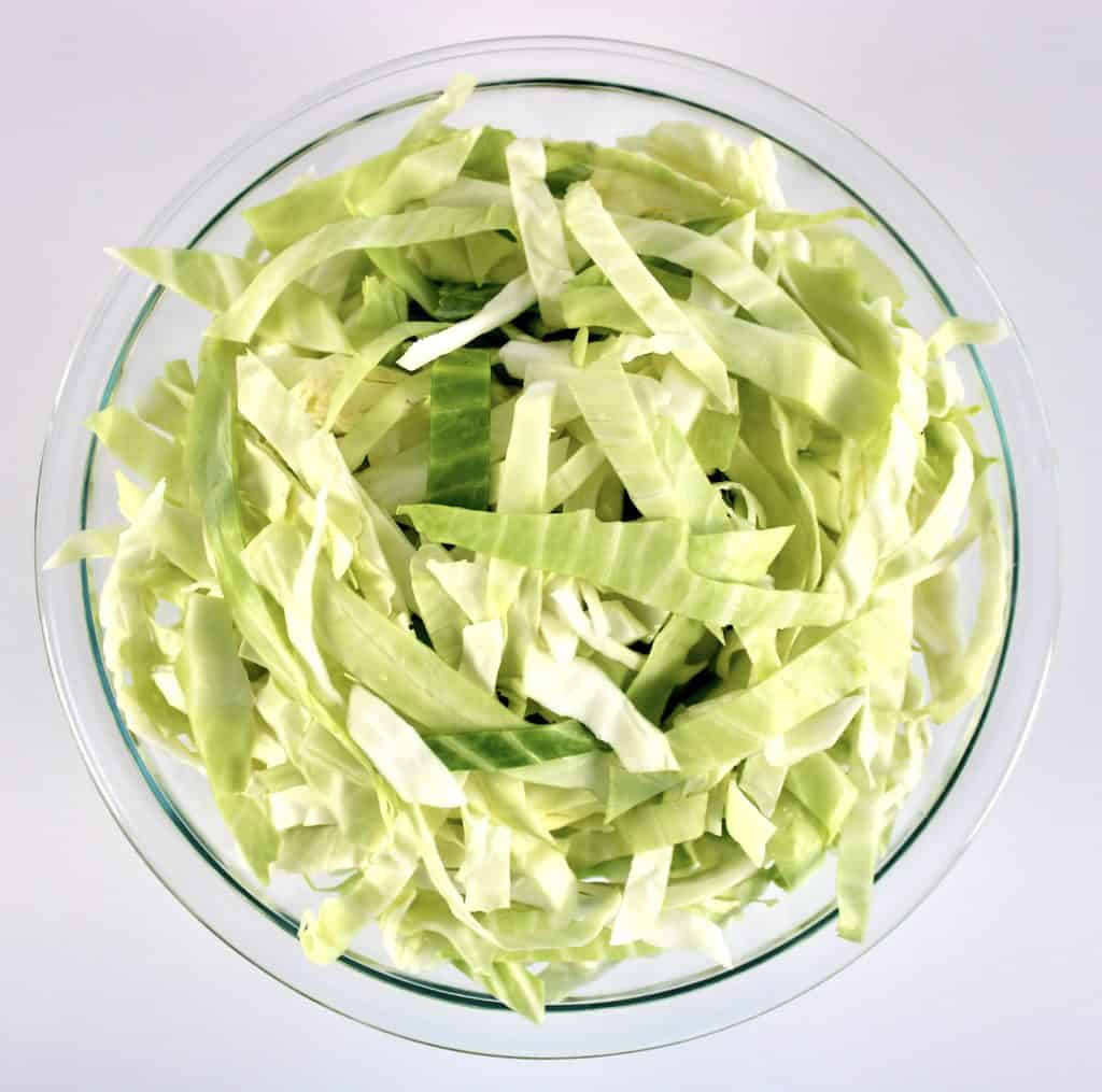 sliced cabbage in glass bowl