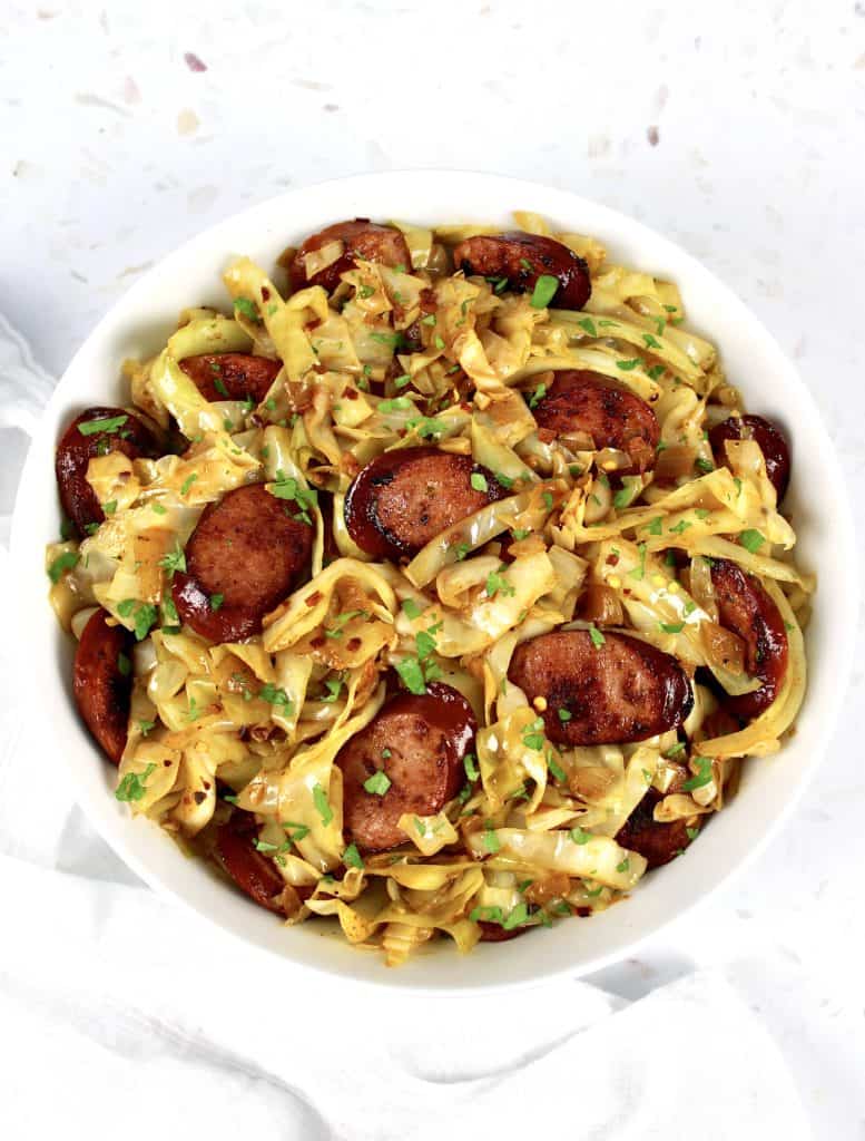 overhead view of Fried Cabbage and Sausage in white bowl