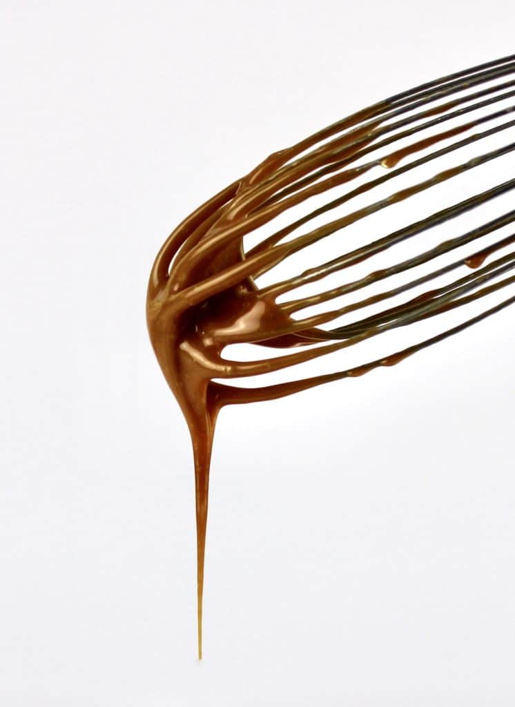 caramel sauce dripping from whisk