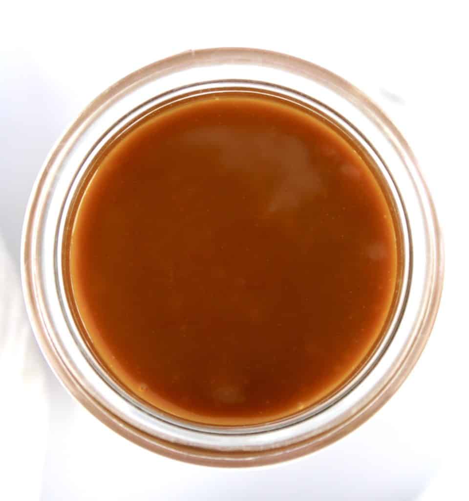 overhead view of caramel sauce in glass jar