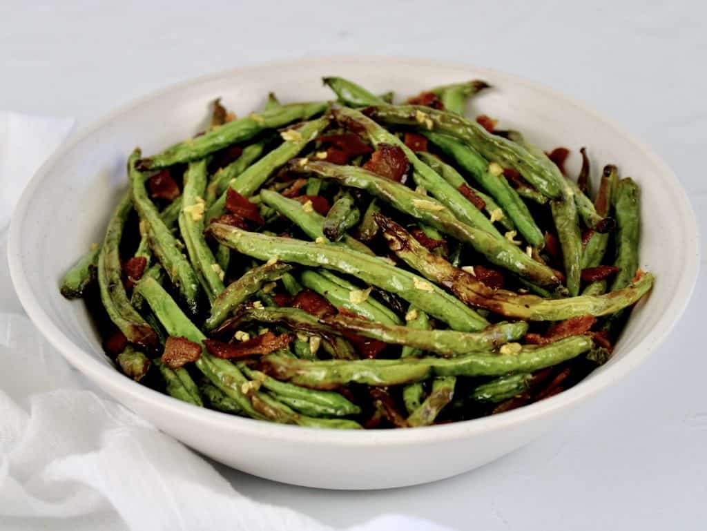 roasted green beans in white bowl