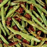 closeup of roasted green beans with bacon chunks