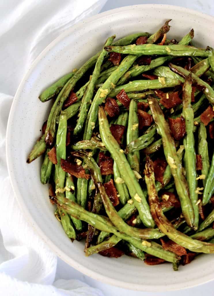 overhead view of roasted green beans in white bowl