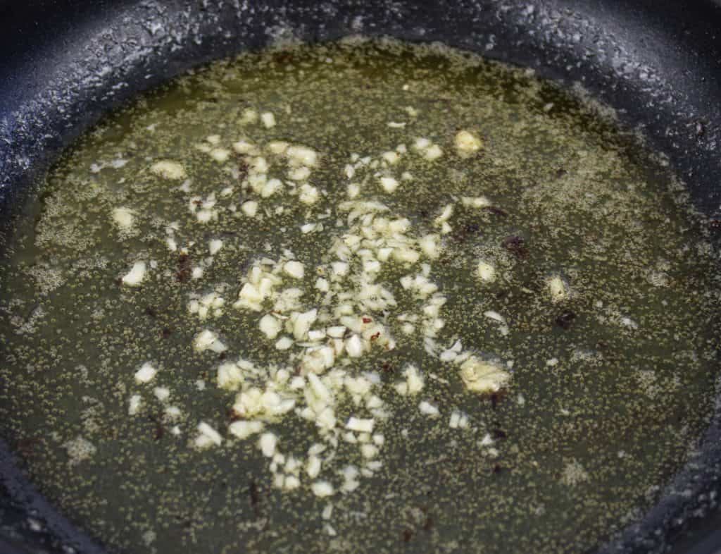minced garlic frying in skillet