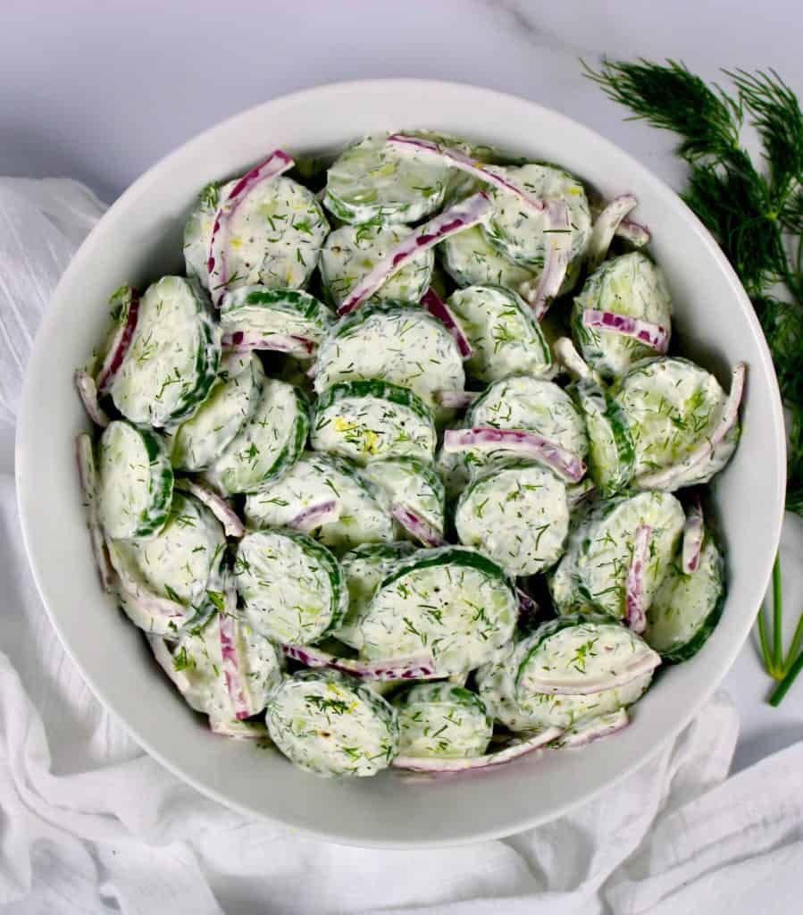 overhead view of Creamy Cucumber Salad on white bowl