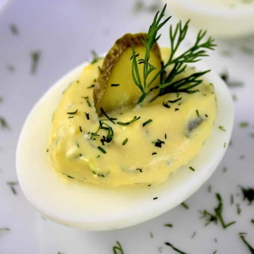 closeup of Dill Pickle Deviled Egg with pickle slice and dill on top