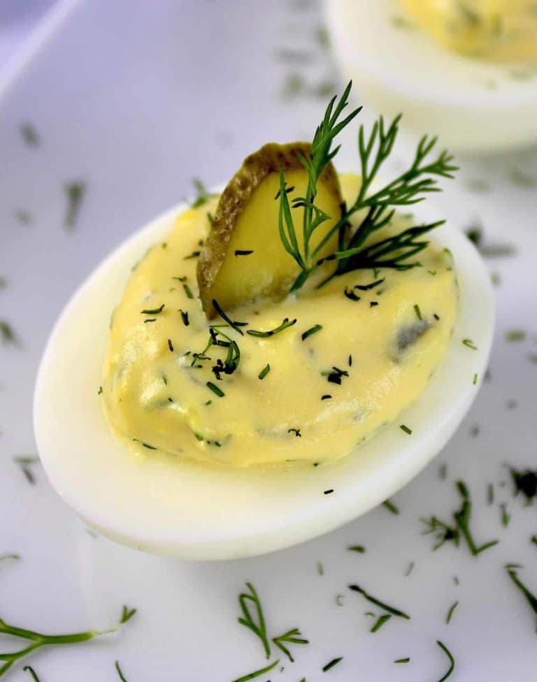 closeup of Dill Pickle Deviled Egg with pickle slice and dill on top