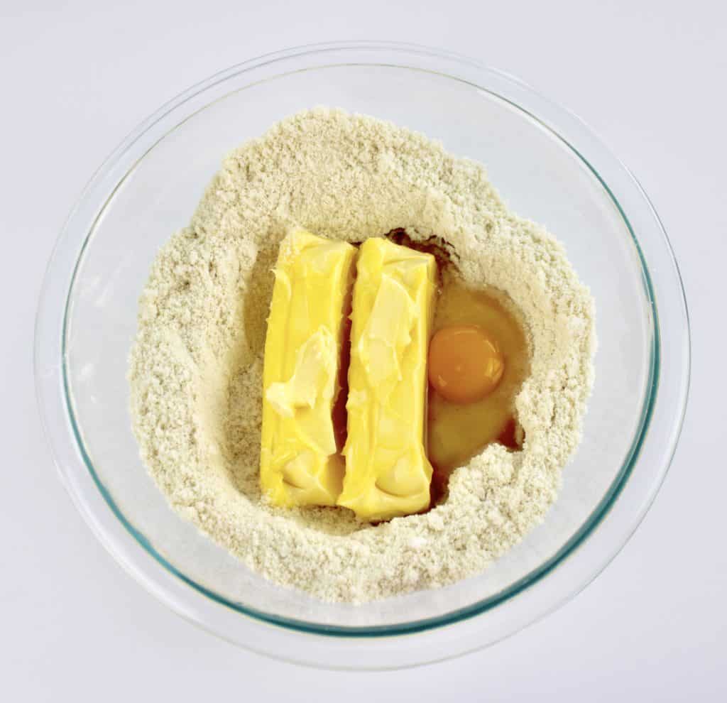 dry ingredients with 2 sticks butter egg in glass bowl