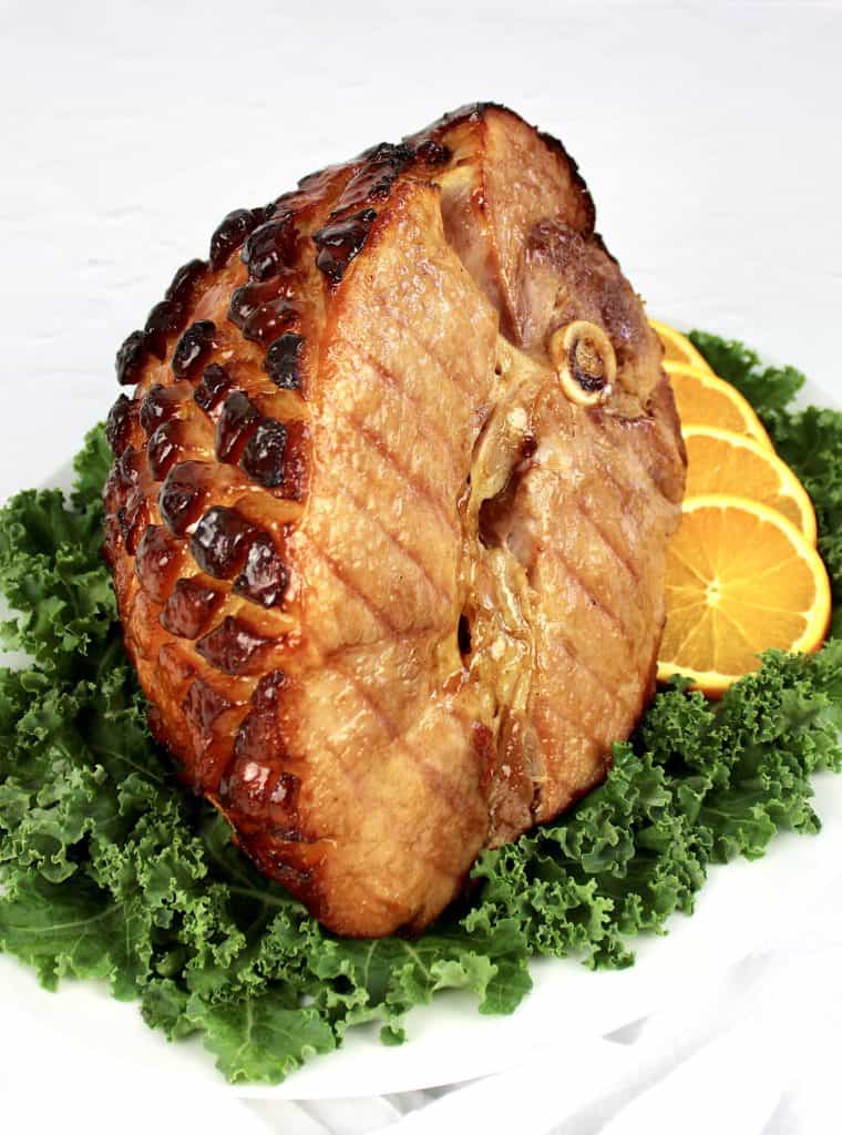 Keto Glazed Ham on platter with kale and orange slices