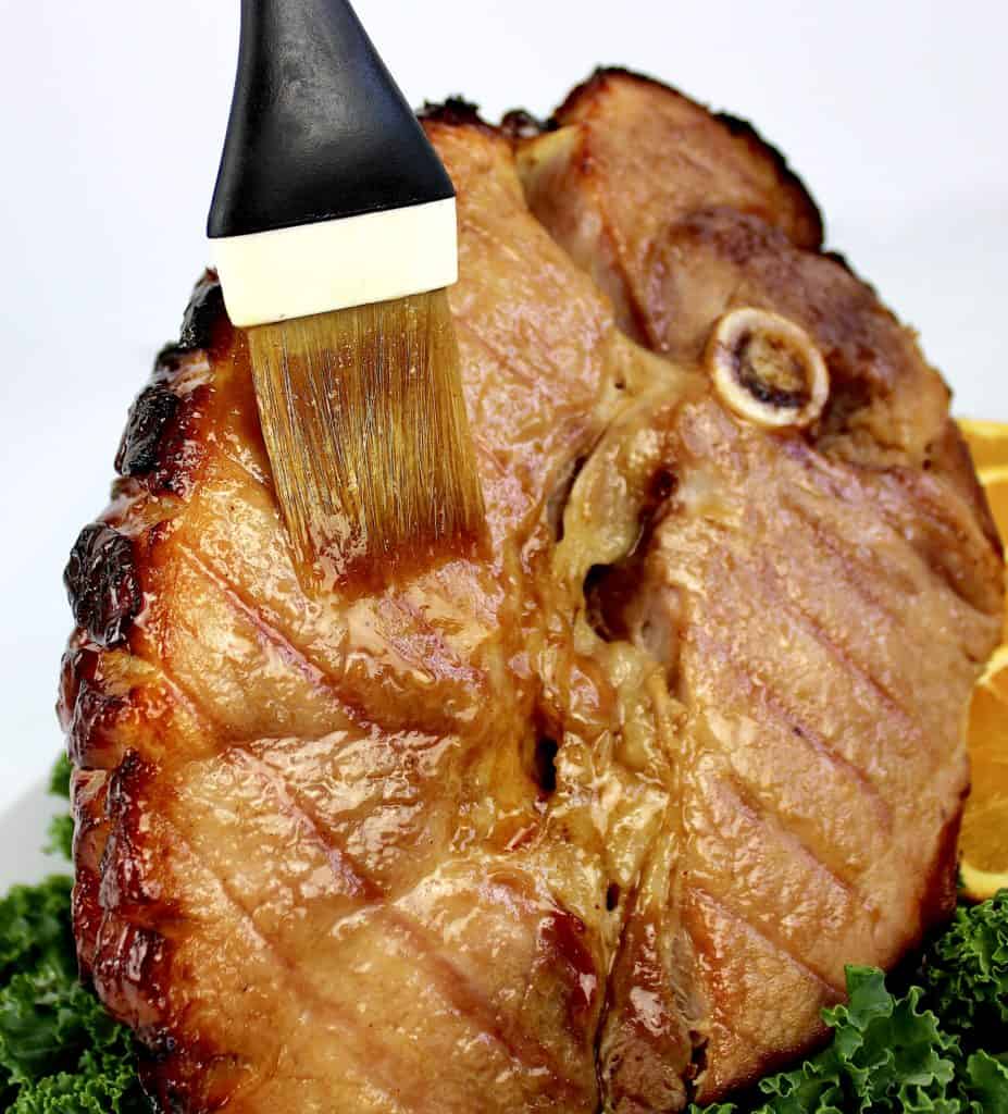 Keto Glazed Ham being brushed with glaze