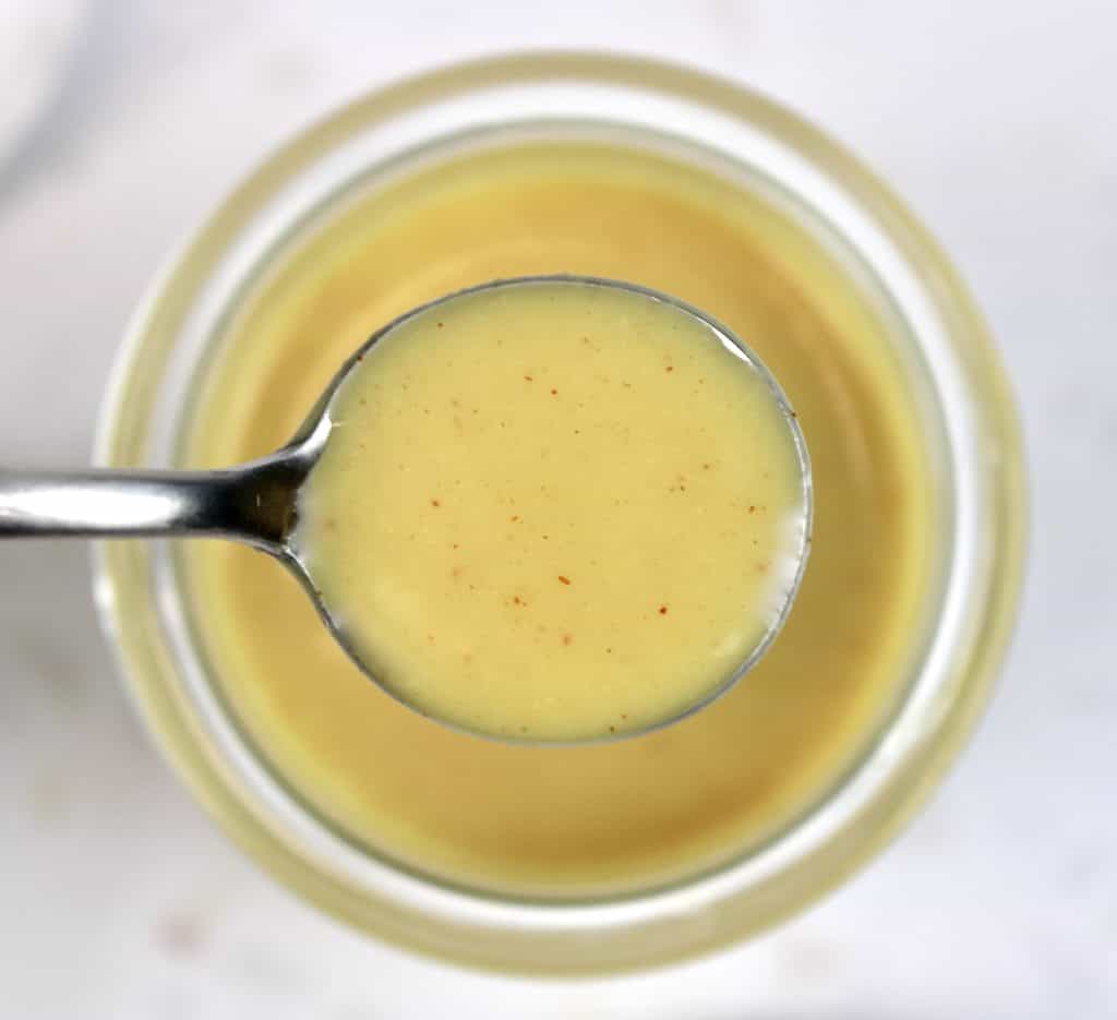 closeup overhead view of honey mustard sauce in spoon