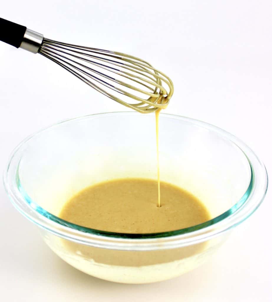 Keto Honey Mustard Sauce in glass bowl mixed with whisk