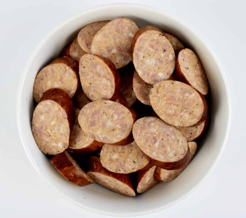 sliced andouille sausage in white bowl