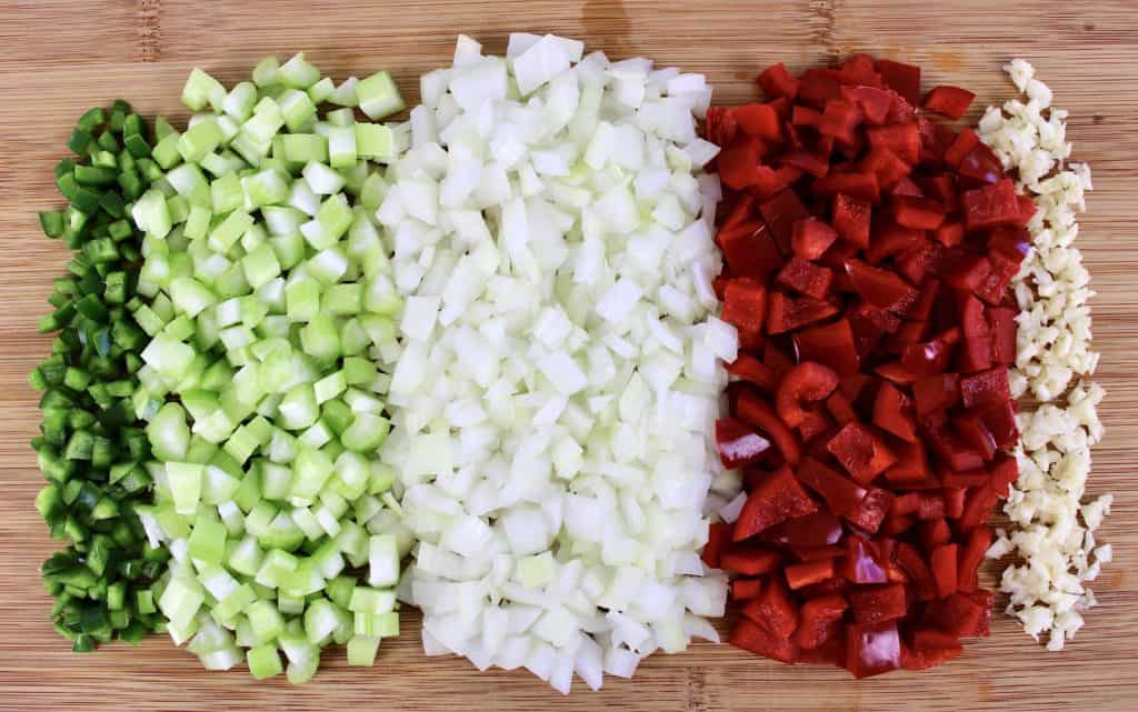 diced peppers onions celery garlic on cutting board