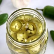 Pickled Jalapeños in open jar