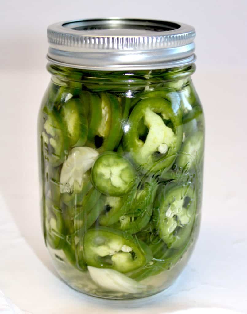 jalapeno peppers in glass jar with lid on top