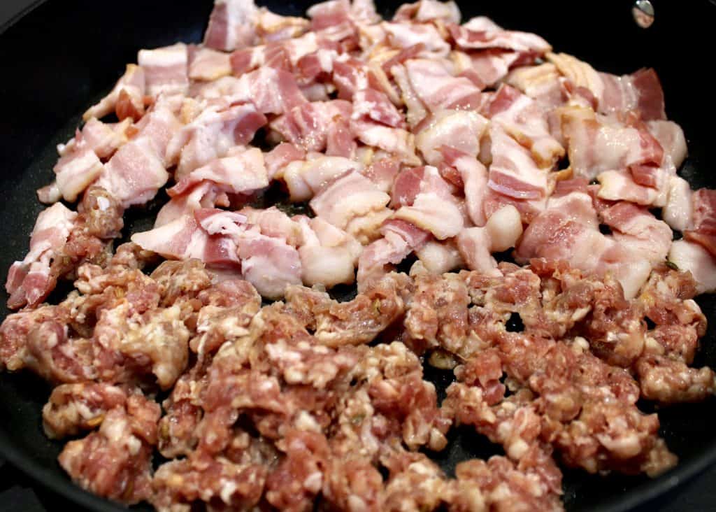 raw chopped bacon and sausage in skillet