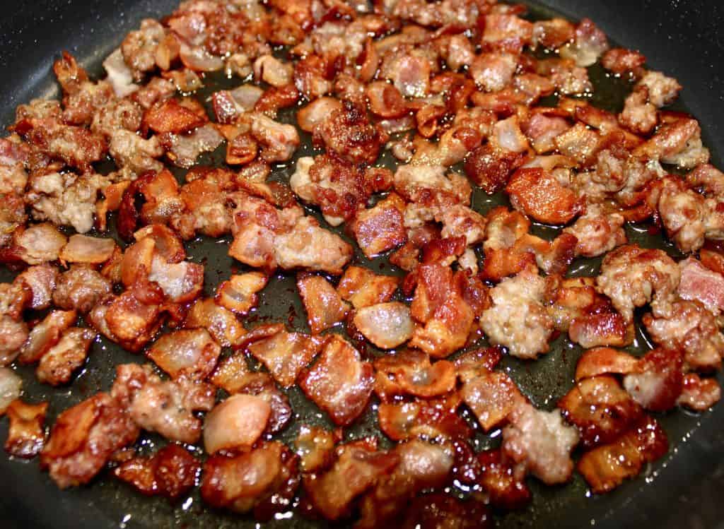 cooked bacon and sausage in skillet