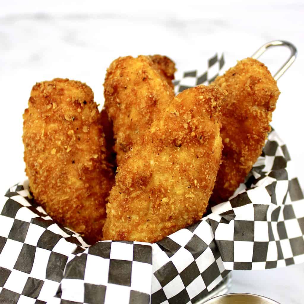 Air Fryer Chicken Tenders in checkerboard paper lined basket