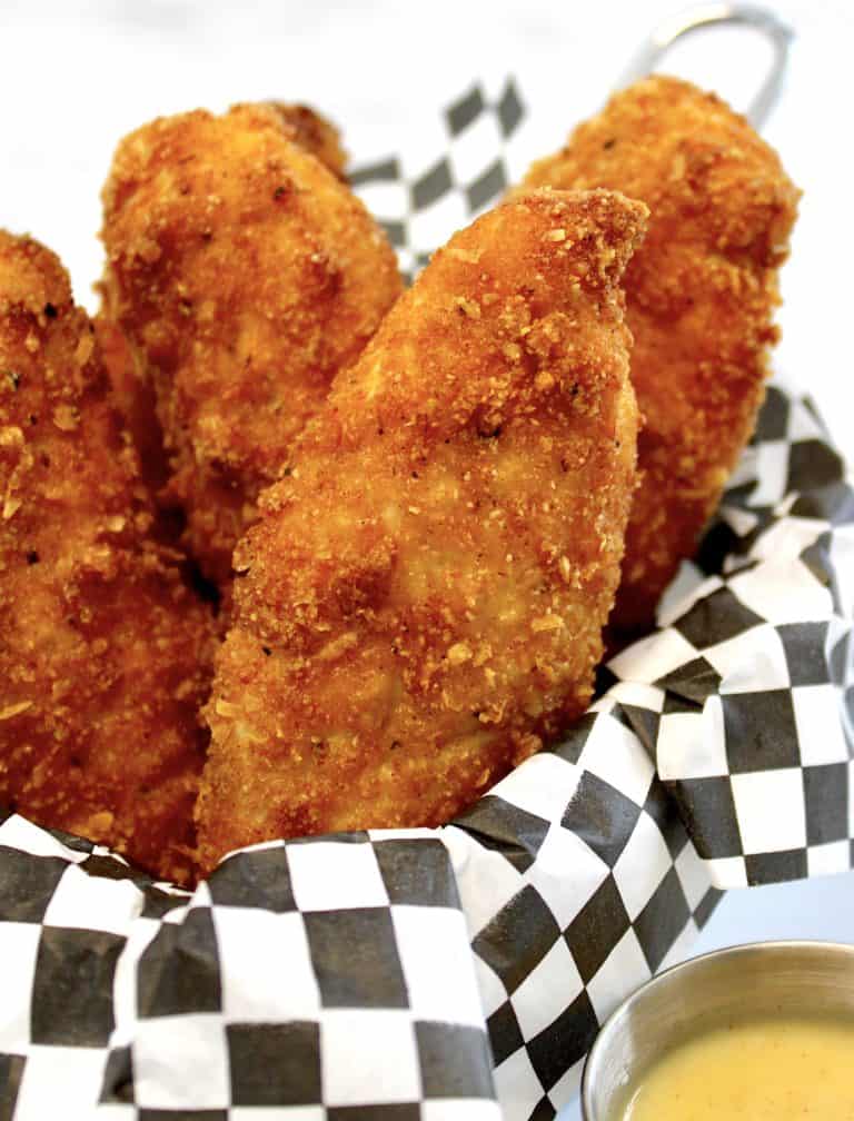 chicken tenders in basket with checkerboard paper
