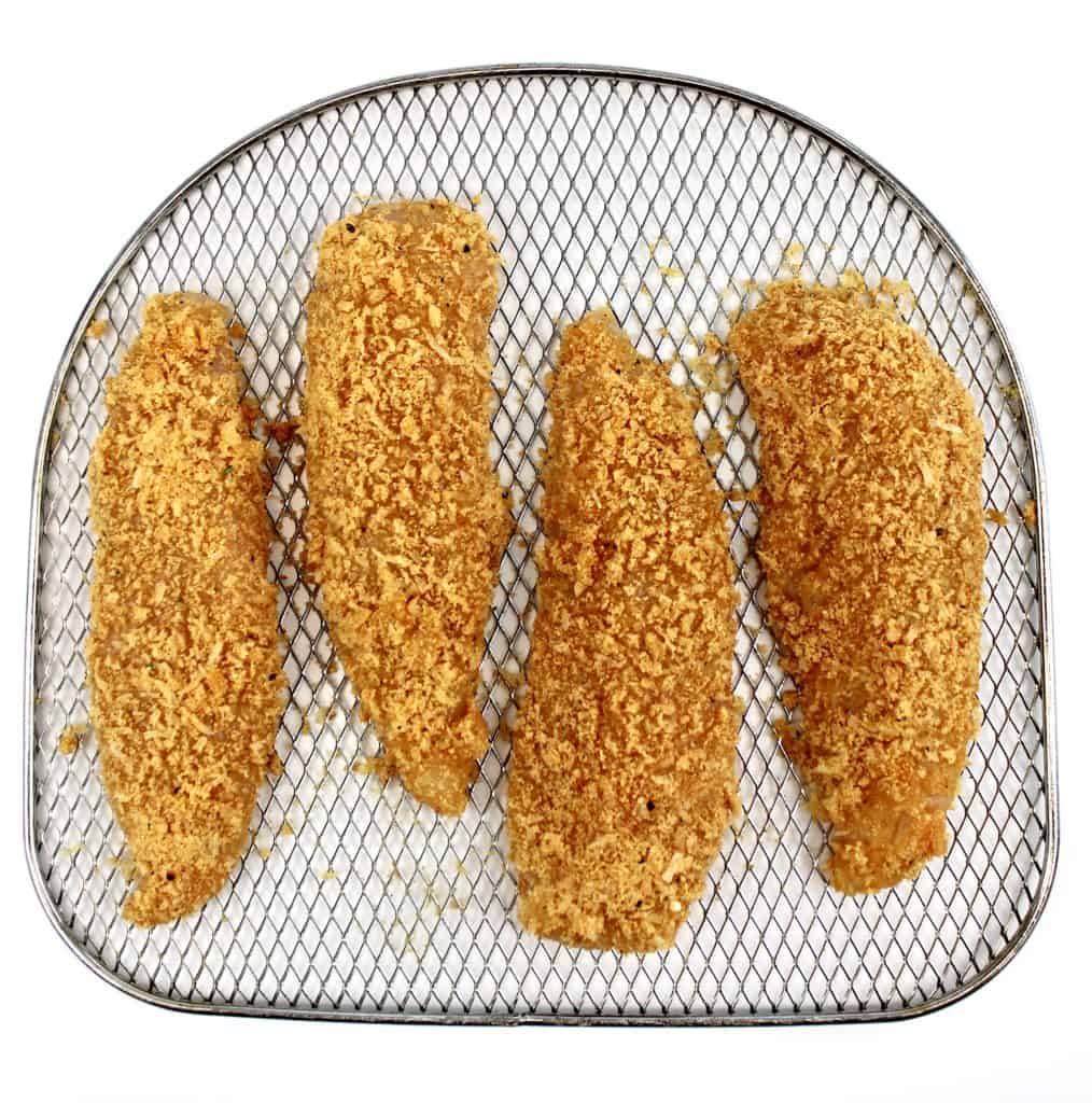 unbaked chicken tenders on air fryer baking rack