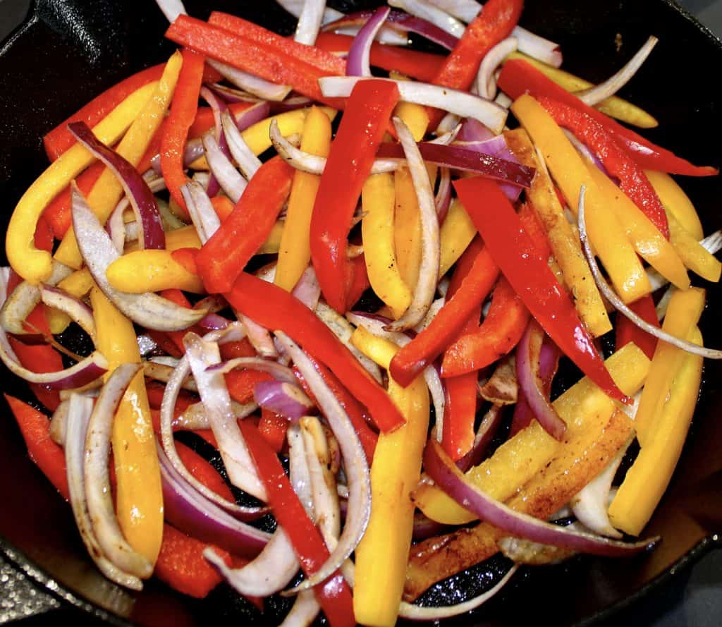 red and yellow pepper and onion strips in skillet