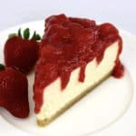 slice of cheesecake with chunky strawberry sauce on top