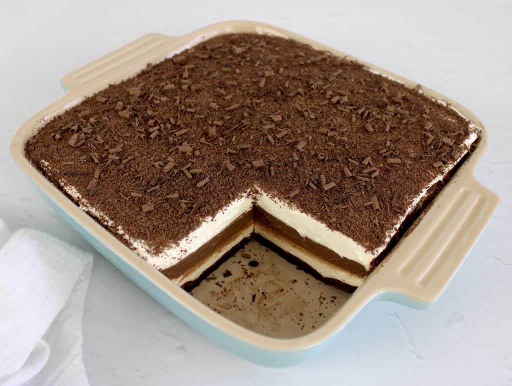 chocolate lasagna in baking dish with shaved chocolate on top