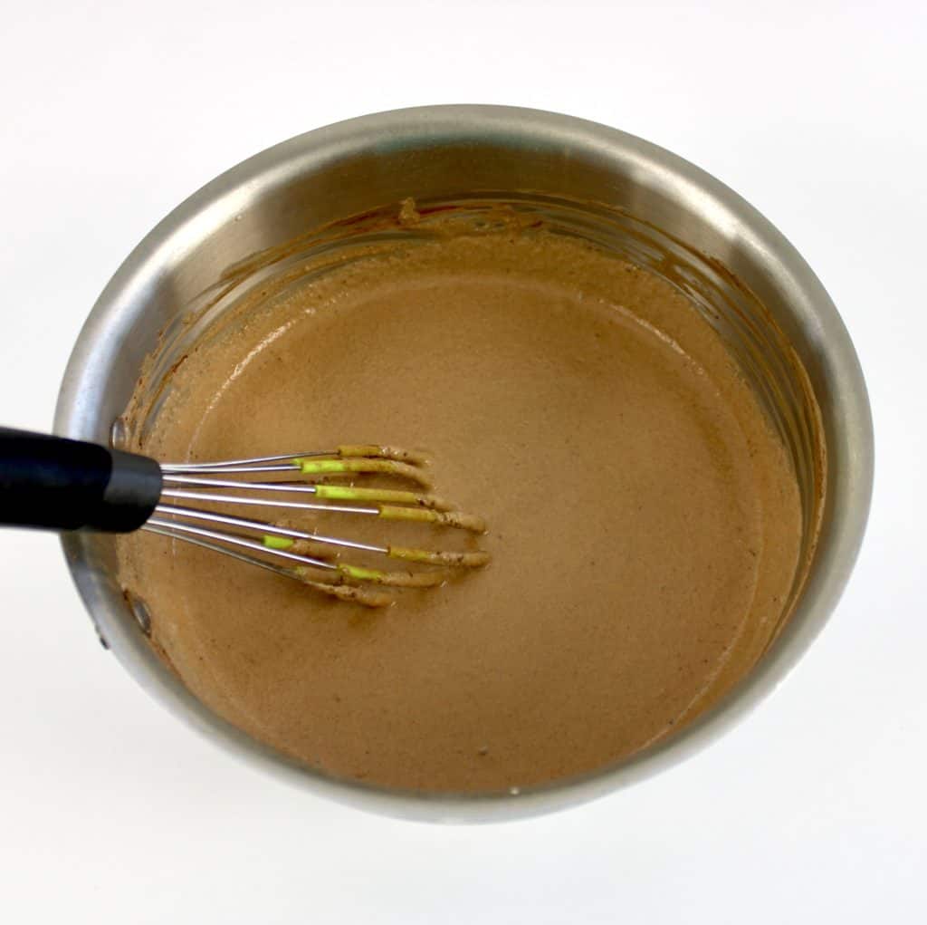 chocolate pudding mixture in saucepan uncooked with whisk